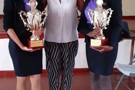 Nurses Osiola Gilbert-Chilcott (left) and Yoshada Khairu (right) pose with their trophies and Gwen Tross at the recent award ceremony. 