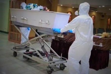 The caskets bearing the bodies of Covid fatalities Premnath Ramkhalawan, 66, and his son Mahindra Nigel Ramkhalawan, 38, being wheeled into the Belgrove’s Funeral Home in San Fernando on Saturday.