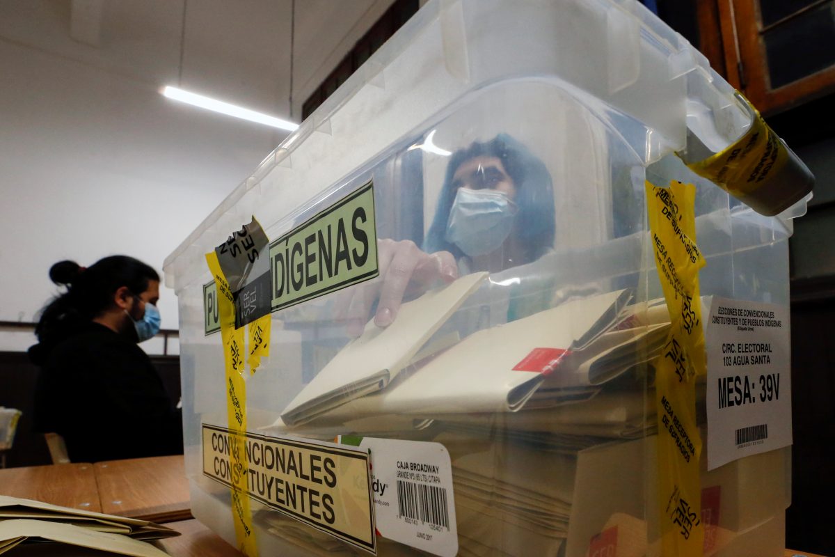 A poll worker wearing protective mask counts the votes in a ballot box after polls closed during the elections for governors, mayors, councillors and constitutional assembly members to draft a new constitution to replace Chile's charter, in Valparaiso, Chile, May 16, 2021. REUTERS/Rodrigo Garrido
