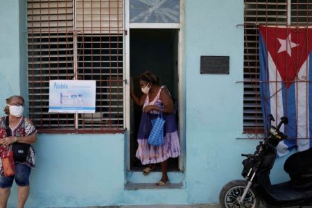 A woman leaves a vaccination center amid concerns about the spread of the coronavirus disease (COVID-19), in Havana, Cuba, May 12, 2021. REUTERS/Alexandre Meneghini