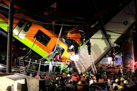 Rescuers work at a site where an overpass for a metro partially collapsed with train cars on it at Olivos station in Mexico City (Reuters photo)