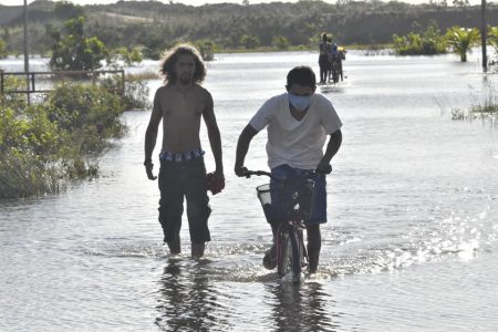 Residents navigating the Region Nine flood on Saturday. (Office of the Prime Minister photo)