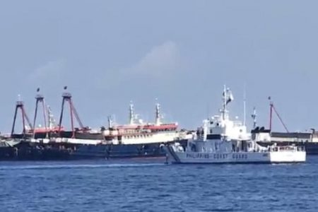 This handout video grab taken on April 27, 2021 and received from the Philippine Coastguard on May 5, 2021 shows the Philippine coastguard ship BRP Cabra (front) monitoring Chinese vessels at Sabina Shoal, a South China Sea outcrop claimed by Manila located about 135 kilometres (73 nautical miles) west of the Philippine island of Palawan. (Philippine Coastguard / AFP)