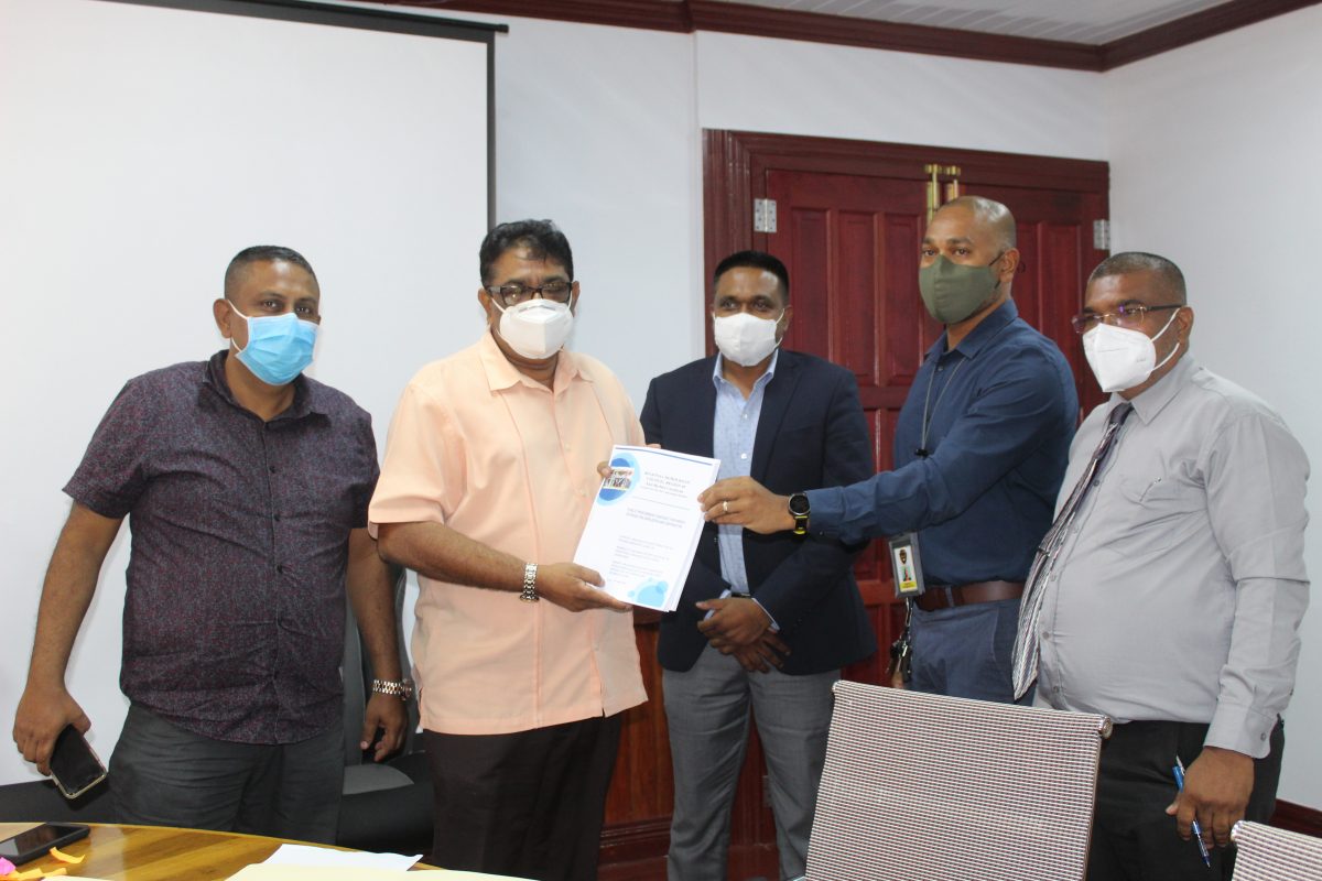 From left are Regional Vice Chairman, Zamal Hussain; Regional Chairman, David Armogan; Minister of Local Government and Regional Development, Nigel Dharamlall; Lancelot Khan, Chief Operations Officer of Queensway Security Service and Regional Executive Officer, Narindra Persaud at the signing of the contracts in the region’s boardroom yesterday.

