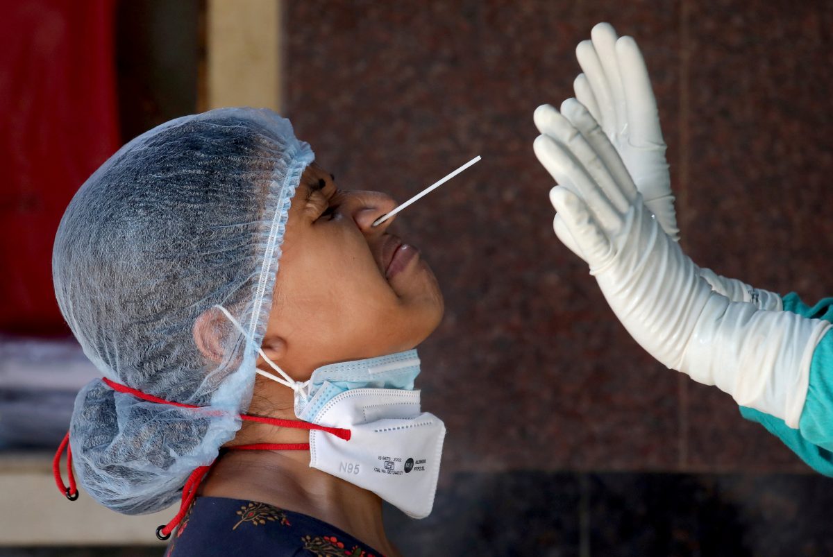 A woman reacts as a healthcare worker takes a nasal swab sample for a coronavirus disease (COVID-19) test at a government-run hospital, amidst the spread of the disease in Kolkata, India, May 6, 2021. REUTERS/Rupak De Chowdhuri