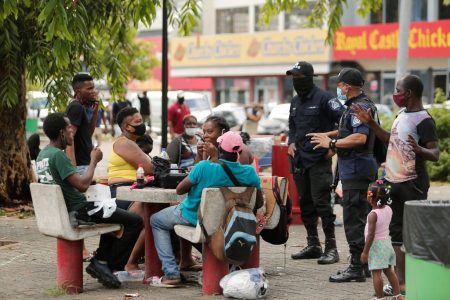 Trinidad policemen speaking to members of the public.