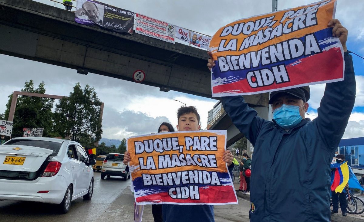 Demonstrators hold signs that read “Duque, stop the massacre, welcome IACHR”, during a street rally in honor of the arrival of the Inter-American Commission on Human Rights (IACHR) to Colombia, in Bogota, Colombia June 6, 2021. REUTERS/Luisa Gonzalez