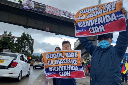 Demonstrators hold signs that read “Duque, stop the massacre, welcome IACHR”, during a street rally in honor of the arrival of the Inter-American Commission on Human Rights (IACHR) to Colombia, in Bogota, Colombia June 6, 2021. REUTERS/Luisa Gonzalez