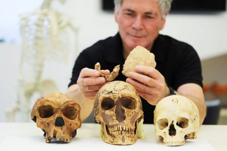 Tel Aviv University Professor Israel Hershkovitz holds what scientists say are two pieces of fossilised bone of a previously unknown kind of early human discovered at the Nesher Ramla site in central Israel, during an interview with Reuters at The Steinhardt Museum of Natural History in Tel Aviv, Israel June 23, 2021. (REUTERS/Ammar Awad photo) 