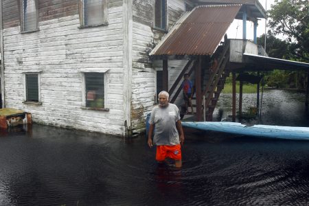 A resident of Big Biaboo makes his way through the floodwater (Orlando Charles photo)