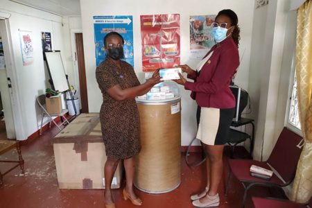 At left is Cleopatra Barkoye, President of the GNA, accepting the donation of the masks from Kezia Nestor-Victor, President of the Young Leaders in Diabetes in Guyana, who handed them over on behalf of the GNAA Inc