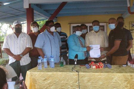 The signing of the contract in Victoria Street, Cumberland Village, East Canje, Berbice on Monday.