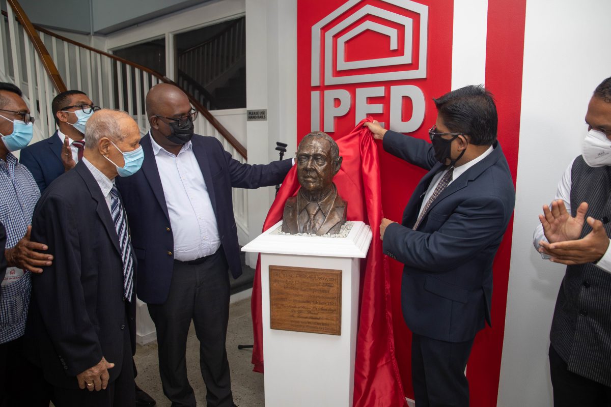 Yesu Persaud (left) at the unveiling of the bust. At right is Minister with responsibility for Finance, Dr Ashni Singh. (IPED photo)