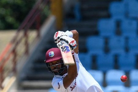 West Indies batsman Roston Chase drives during his top score of 62 on the third day of the opening Test yesterday. 