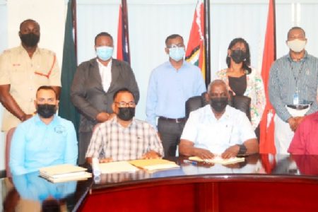 Minister Robeson Benn (seated second from right) with the board. (Ministry of Home Affairs photo)