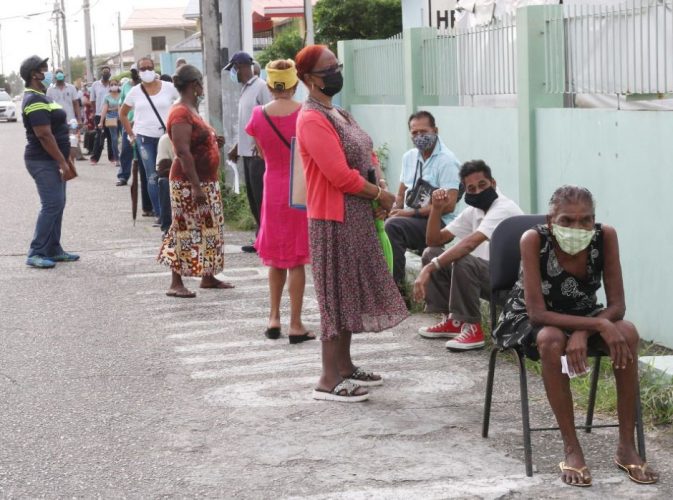 People wait to get the COVID- 19 vaccine outside the the Barataria Health Centre on Seventh Street, Barataria, yesterday. 