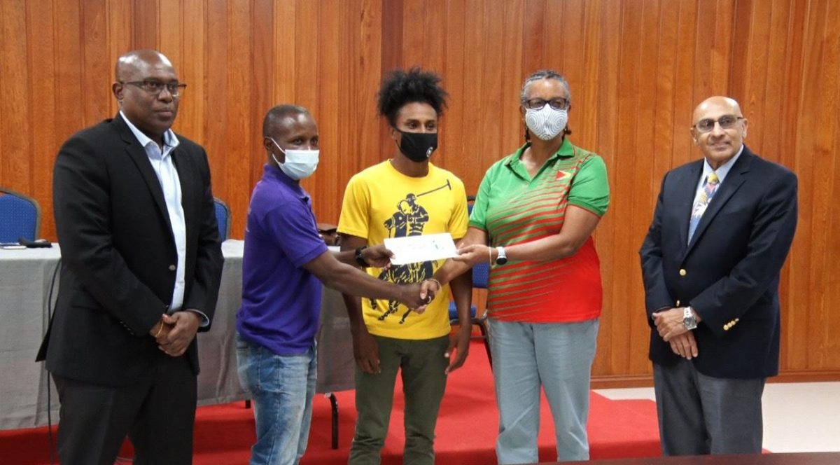 Vice President if the GOA, Dr. Karen Pilgrim, ceremoniously presented a sponsorship cheque to Coach, Sebert Blake who will accompany star boxer, Keevin Allicock to the training camp and the Olympic Games. They are flanked by President of the Guyana Boxing Association (GBA), Steve Ninvalle (left) and President of the GOA, K Juman-Yassin.

