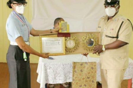 Constable Persaud receiving her awards from Officer-In-Charge of Traffic in Region Six Assistant Superintendent of Police Raun Clarke last month