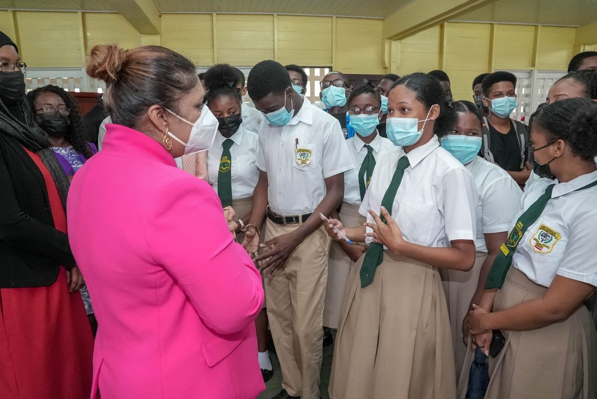 Minister of Education, Priya Manickchand (left) speaking with students of the North Ruimveldt Multilateral Secondary School following the meeting yesterday. (Ministry of Education photo)