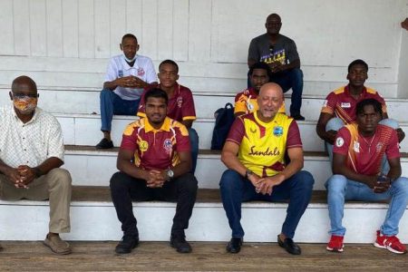 Cricket West Indies president Ricky Skerritt, second from right (sitting), with the five players.