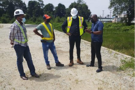 Director of Sport, Steve Ninvalle (right) held discussion with the consultant (second from right) and the engineers on the project yesterday in Berbice. 