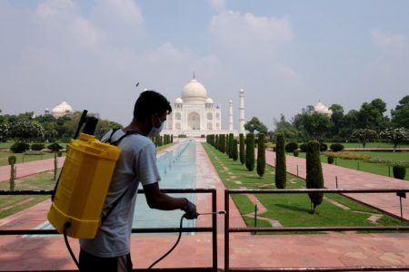 FILE PHOTO: A man sanitizes railings in the premises of Taj Mahal after authorities reopened the monument to visitors, amidst the coronavirus disease (COVID-19) outbreak, in Agra, India, September 21, 2020. REUTERS/Alasdair Pal/File Photo