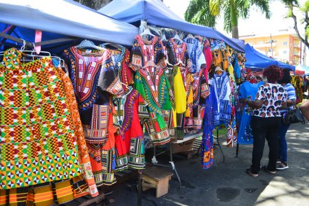 African print clothing on full display on Friday at a stall along Main Street Avenue, Georgetown, where the Main Street Emancipation Bazaar is being held. Small businesses displayed clothing and jewellery, among other items at the bazaar. (Orlando Charles photo)