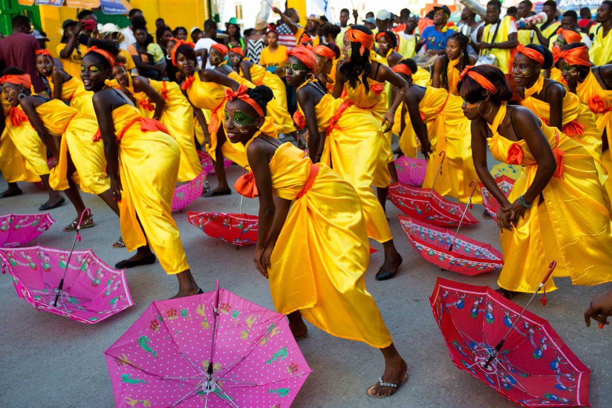 Women dancing at a Haitian carnival (Britannica.com photo)