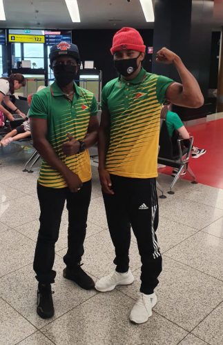 Olympic Games bound boxer Keevin Allicock and his coach Sebert Blake pose for a photo shortly after arriving in Moscow, Russia yesterday