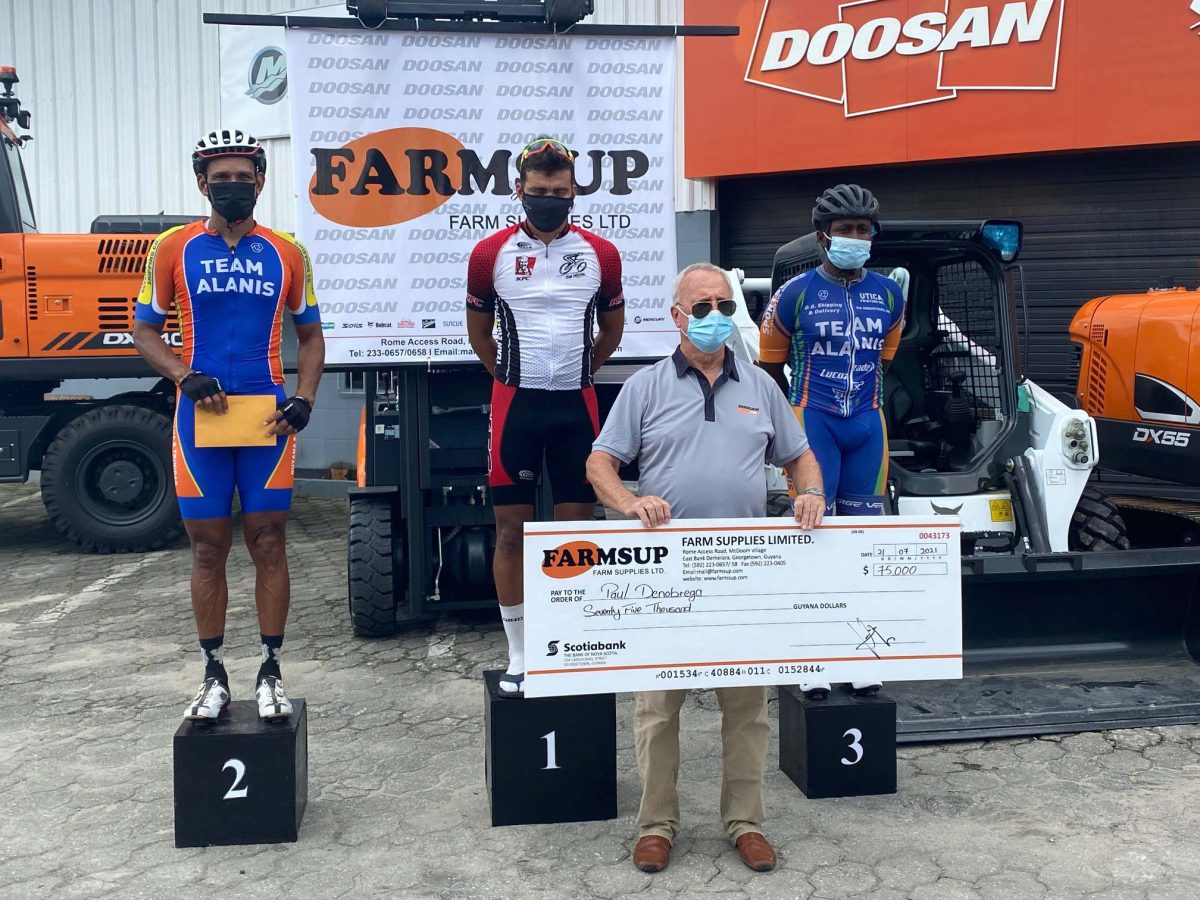 Managing Director of Farmsup/Doosan, Renger van Dijk is flanked by the podium finishers in yesterday’s 45-mile road race. Paul DeNobrega (centre), earned the first place prize while Team Alanis’ Paul Choowenam (left) and Kemuel Moses (right) finished second and third in the highly competitive event. (Emmerson Campbell photo)