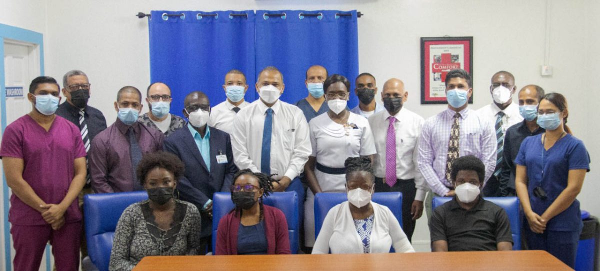 Dr. Germaine Bristol (seated second from right) and her son Gerome Bristol (seated at right) along with Dr. Nyamekeye Griffith (seated second from left) flanked by Minister of Health Dr. Frank Anthony (standing near centre with tie), the ministerial advisor and team from the transplant department. (Ministry of Health photo)