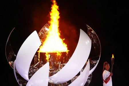 Japan’s tennis star Naomi Osaka holds the Olympic torch after lighting the Olympic cauldron at the Tokyo 2020 Olympics Opening Ceremony at Olympic Stadium, Tokyo, Japan on Friday.  (REUTERS/Mike Blake photo) 
