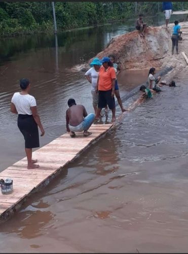 Residents construct a bridge across the section of the road which was washed away when the East Montgomery tailings pond broke 