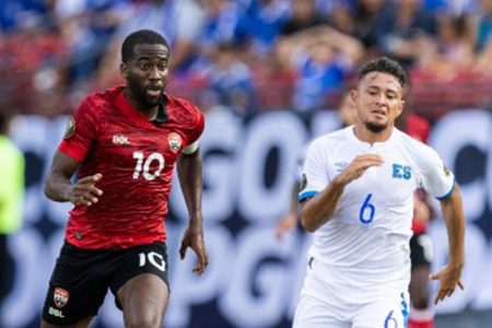 Trinidad and Tobago’s Kevin Molino chases Narciso Orellana during Wednesday’s contest against El Salvador.