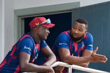  West Indies captain Kieron Pollard (right) deep in discussion with senior
all-rounder Jason Holder, following the abandonment of the second ODI yesterday.