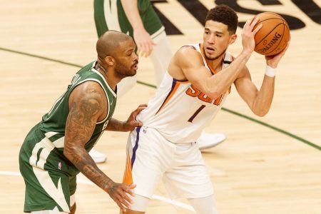 Devin Booker, right, had an off night Sunday scoring only 10 points on three of 14 shots.
