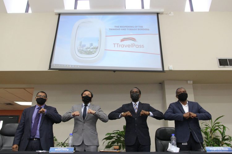 Government Ministers, from left, Rohan Sinanan, Stuart Young, Fitzgerald Hinds and Hassel Bacchus touch elbows after the Border Reopening media conference at the Ministry of Works and Transport in Port-of-Spain yesterday.