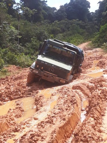 A small truck navigating its way through the deplorable trail 