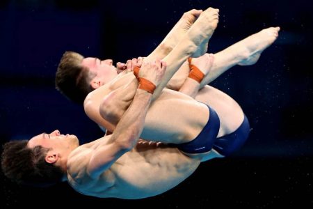 Thomas Daley of Britain and Matty Lee of Britain in action in men’s synchonised diving. REUTERS/Marko Djurica.