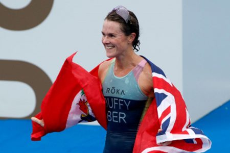 Bermudian Flora Duffy celebrates with the country’s flag after winning gold in Tokyo. 