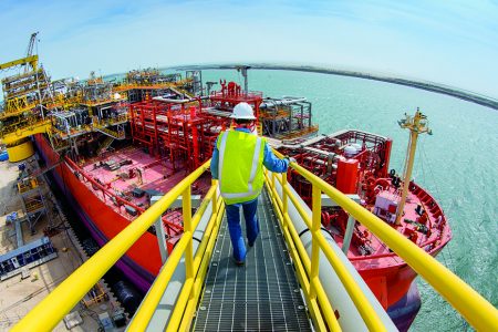 A worker approaches one of the MWCC's rapid-response vessels that can be deployed to capture, process, store and offload liquids during a subsea incident. (ExxonMobil photo)