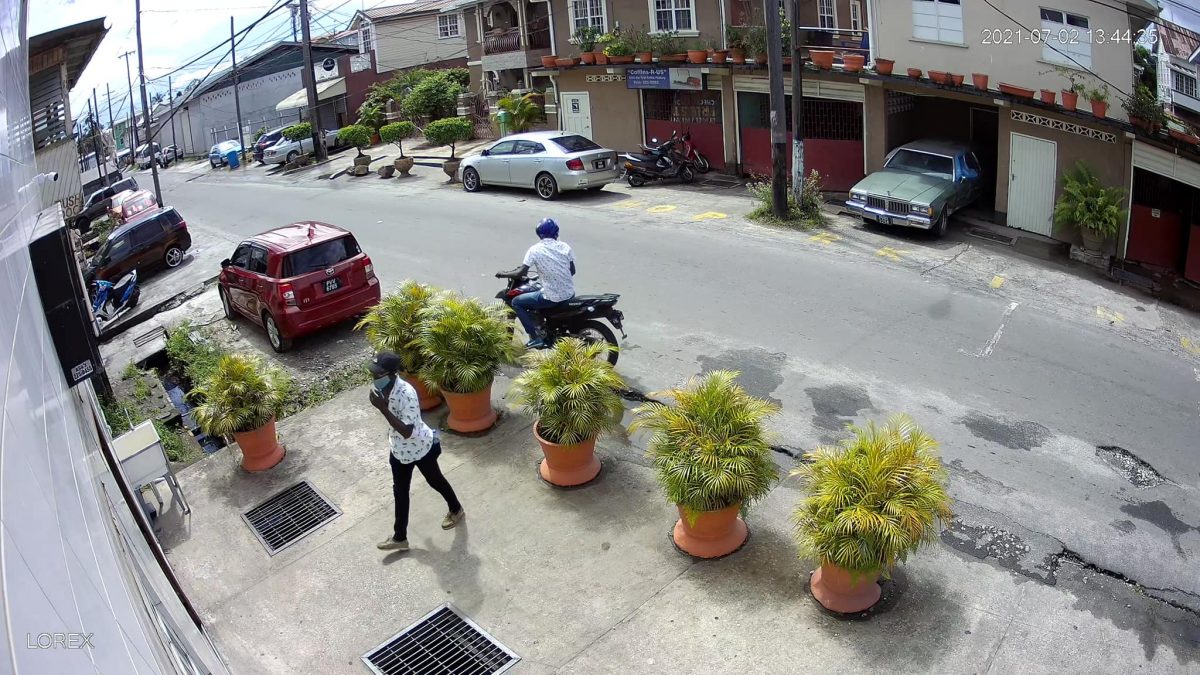 The bandit entering the funeral home while his accomplice waited on the motorcycle