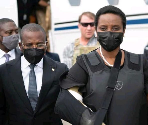 Haiti's interim Prime Minister Claude Jospeh walks with the Haiti's first lady Martine Moise, the wife of assassinated President Jovenel Moise, after she arrives from the U.S, in Port-au-Prince, Haiti, in this undated photograph obtained by Reuters on July 17, 2021. Prime Minister's Office/Handout via REUTERS