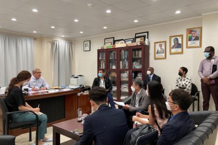 Members of the South Korean delegation in discussion with Commissioner General Godfrey Statia (sitting at desk) (GRA photo)