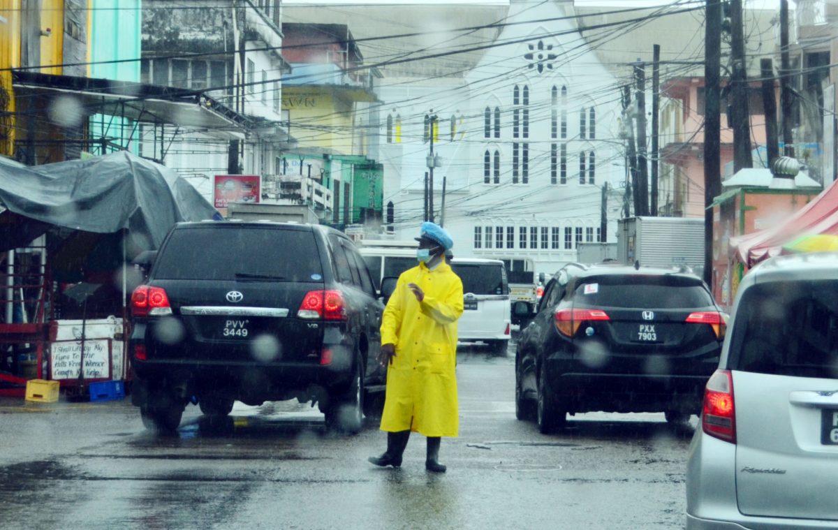 A  policeman at Regent and King streets directing traffic during yesterday’s rain in the city. 