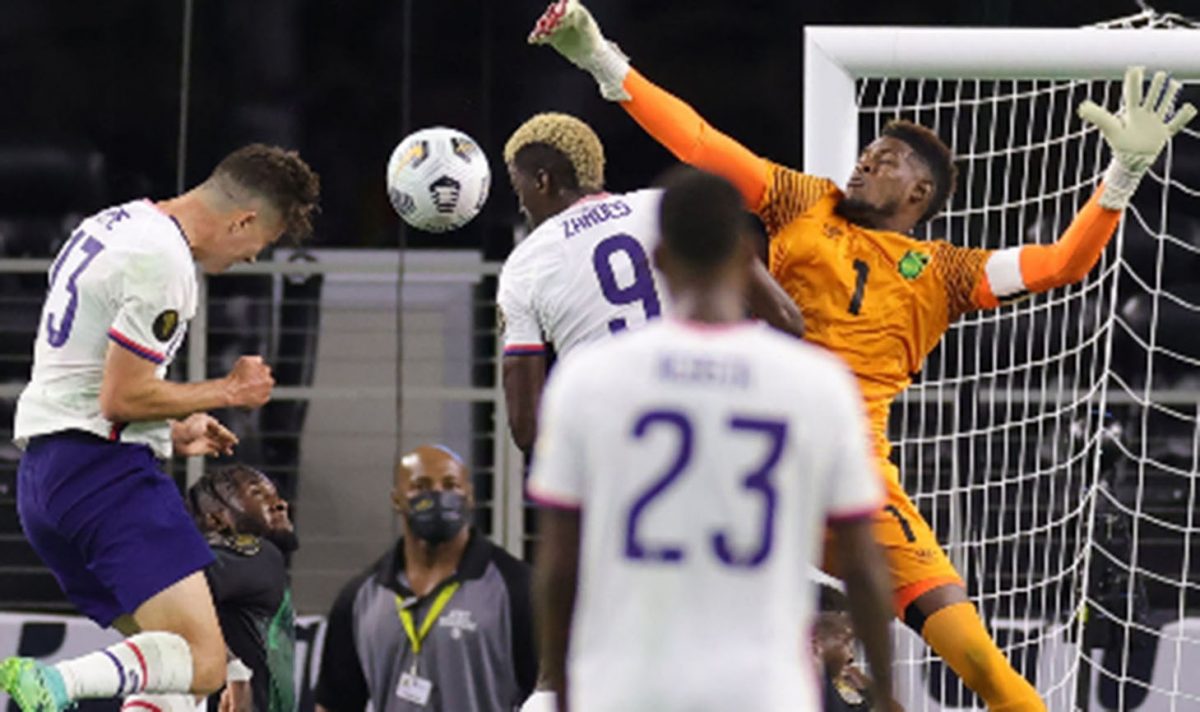 Jamaica goalkeeper Andre Blake misses his clearance as Matthew Hoppe (left) secures the winning header for United States.
