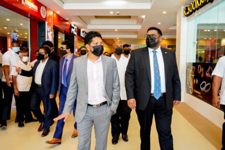 President Irfaan Ali (right) and Ramnaresh Sarwan (second from right) touring the mall yesterday. (Office of the President photo)