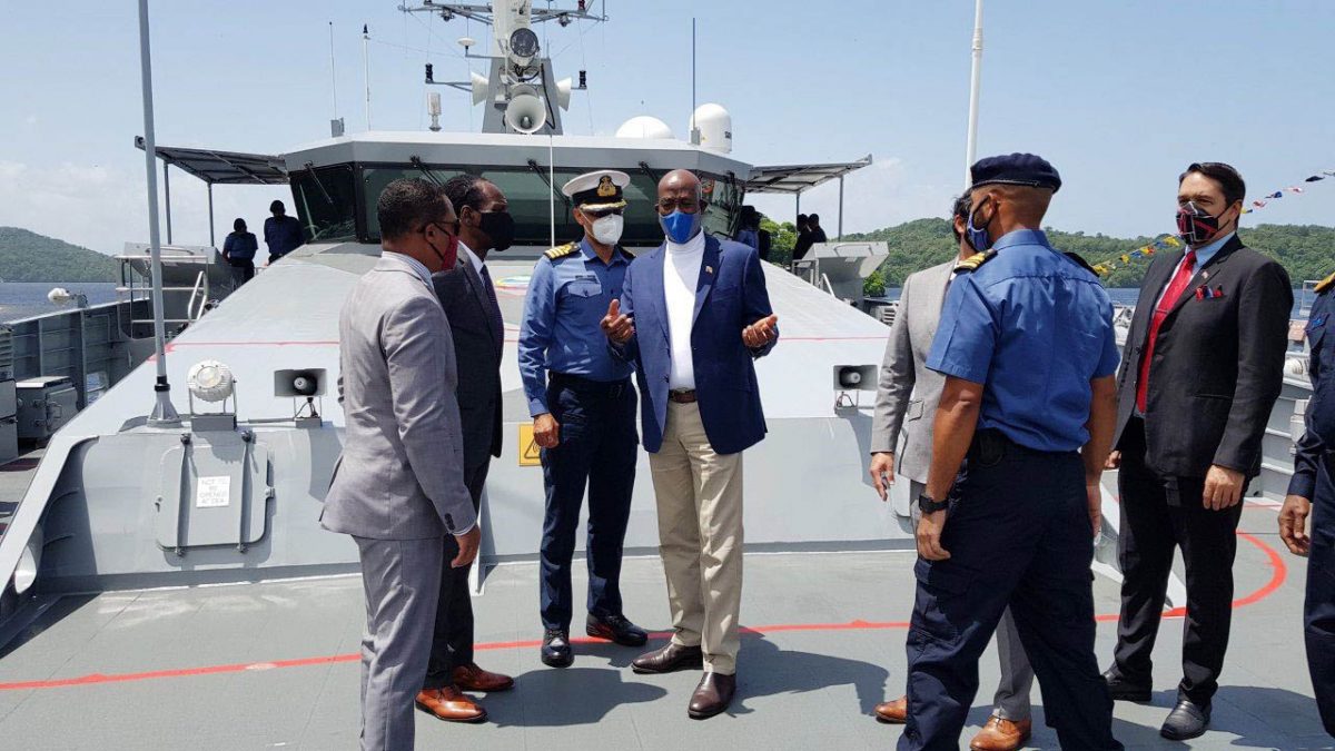 Prime Minister Dr Keith Rowley, centre,  yesterday.
