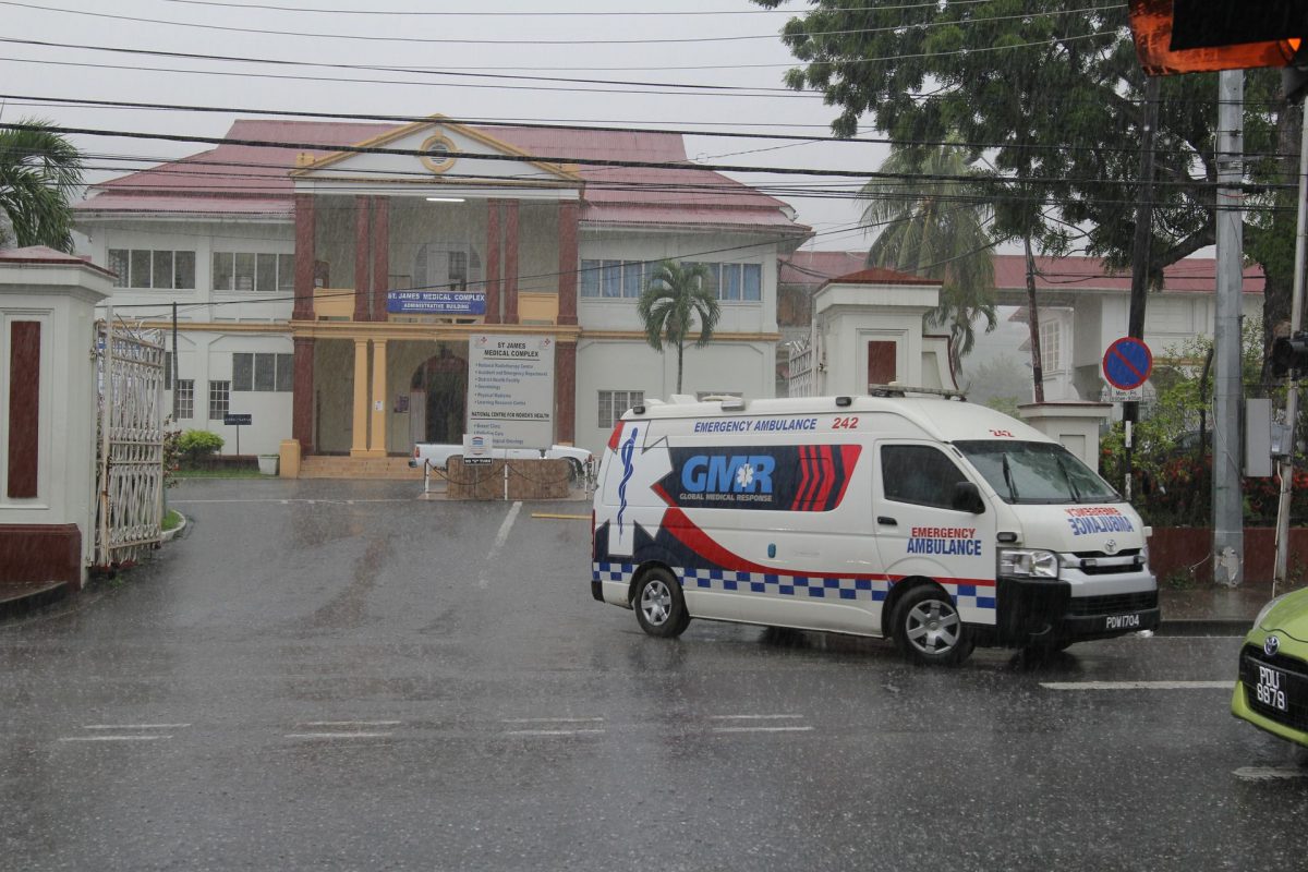 An Ambulance leaves the St James Medical Complex, Western Main Road, St James.