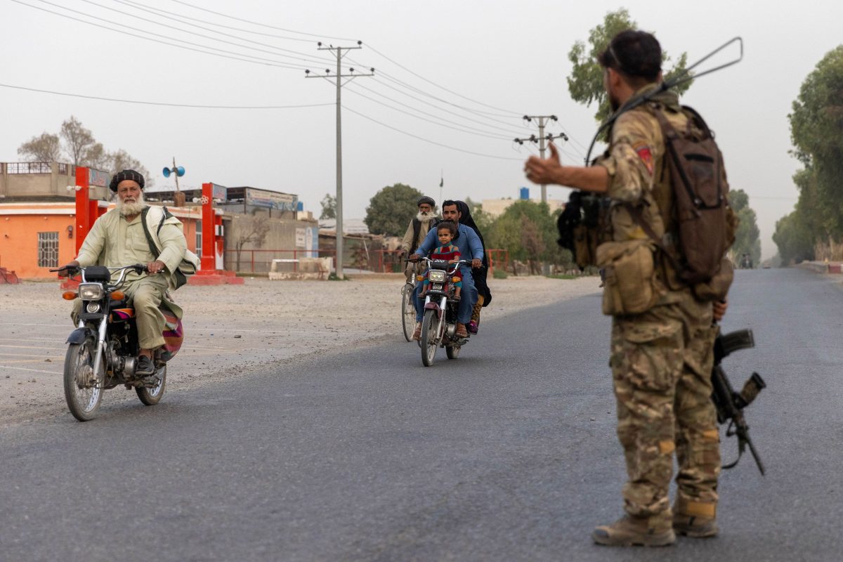 FILE PHOTO: A member of the Afghan Special Forces directs traffic during the rescue mission of a policeman besieged at a check post surrounded by Taliban, in Kandahar province, Afghanistan, July 13, 2021. Picture taken July 13, 2021.REUTERS/Danish Siddiqui